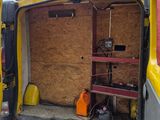 a van that has been vandalized with plywood boards