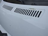 a close up of the hood of a white car