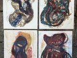 four paintings of different shapes and sizes on paper on a sidewalk