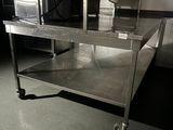 a large stainless steel table in the middle of a room