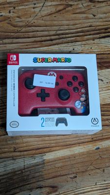 the nintendo wii controller is in the box on the table
