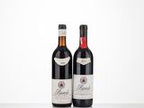 two bottles of wine sitting on top of a table next to each other