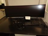 a computer desk with a monitor and keyboard on it