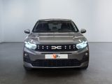 the front view of a silver car in a white room