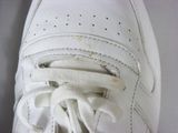a close up of a pair of white shoes with laces on them