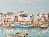 many boats in the water near a row of houses