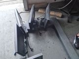 two televisions that are sitting on the ground next to each other