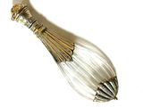 a silver spoon with a glass handle on a white surface