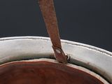 a close up of a brown leather hat with a leather strap