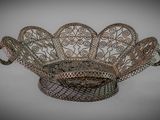an ornate metal basket with a decorative design on it
