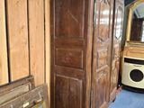 a picture of a wooden cabinet and a mirror in a room