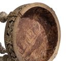 a wooden bowl with a handle on a white surface