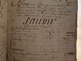 an old book with writing on it sitting on a table