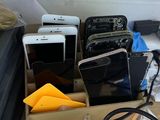 several cell phones are sitting in a box on a desk