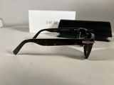 chanel tortoise sunglasses with box and case on a table