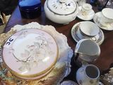 a table with a lot of dishes and cups on it