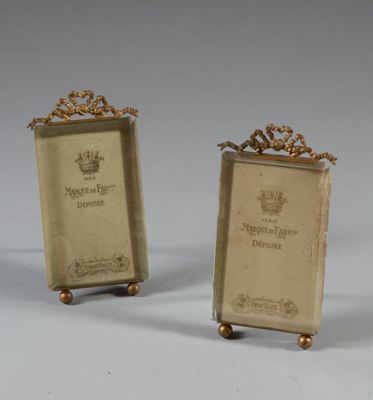 pair of antique brass bookends with a crown on each of them