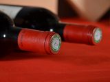two bottles of wine sitting on a red table