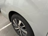 a white car parked in a parking lot next to a parking meter