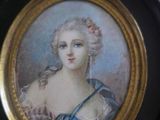 painting of a woman in a blue dress in a gold frame