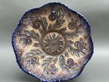 a blue and white plate with a peacock design on it