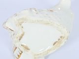an image of a white bird shaped dish with a gold rim