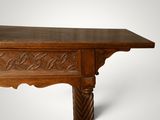 an image of a wooden table with a carved top on a white background