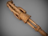 an old wooden stick with a wooden handle on a gray background