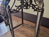 a metal lantern on a wooden table in a room