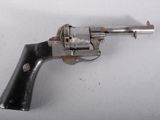 a gun that is sitting on a white surface