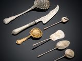 several different types of spoons and utensils on a black surface