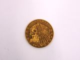 a close up of a gold coin on a white surface
