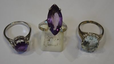 three different rings and a ring with a purple stone
