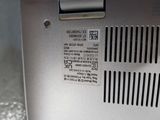 a close up of a silver laptop with a sticker on it