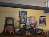 a desk with a lamp, a chair, and pictures on the wall