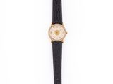 a close up of a wrist watch on a white surface