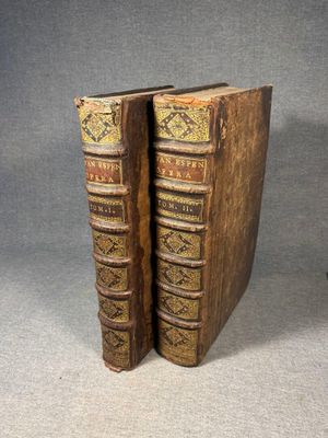 a pair of old books sitting on top of each other