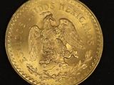 an image of a gold mexican coin on a black background