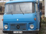 a blue truck that is parked in front of a house