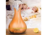 a small child sleeping in bed next to a wooden diffuser