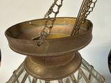 a large metal bowl with chains hanging from it