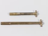 two antique brass screws on a white background