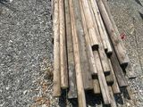 a pile of wood sitting on the ground next to a boat