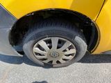 a yellow car that has a flat tire on it