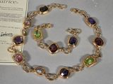 gold plated bracelet and earrings with multi colored stones on display