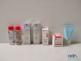 many different types of skin care products displayed on a table