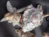 a figurine of a little girl with angel wings and a teddy bear