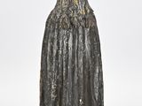 an old statue of a woman with a cloak on her head