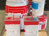several buckets of paint sitting on top of a wooden pallet