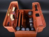 a brown case with tools inside of it on a black background